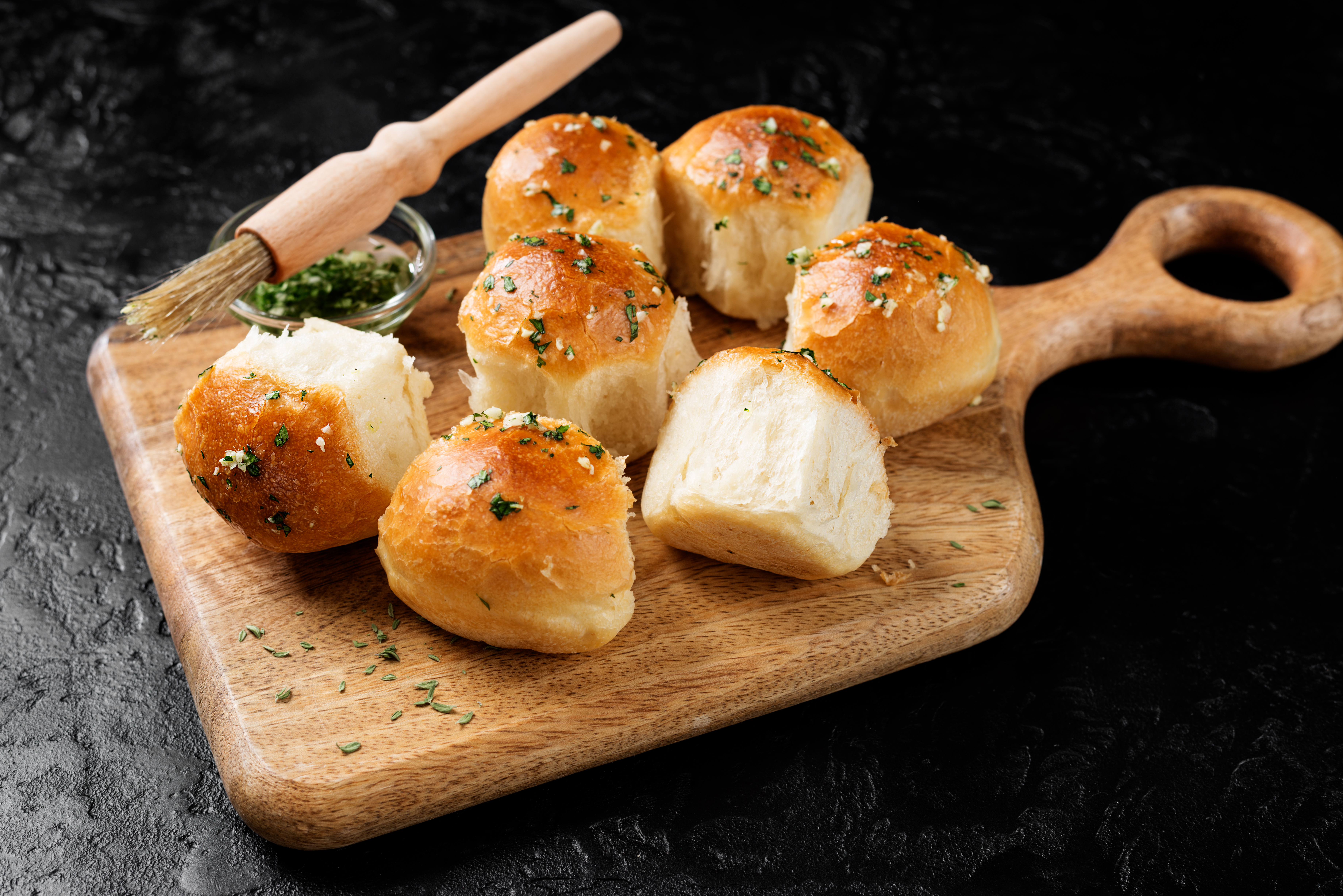 Fresh baked Homemade Garlic Butter Buns. Black  background.