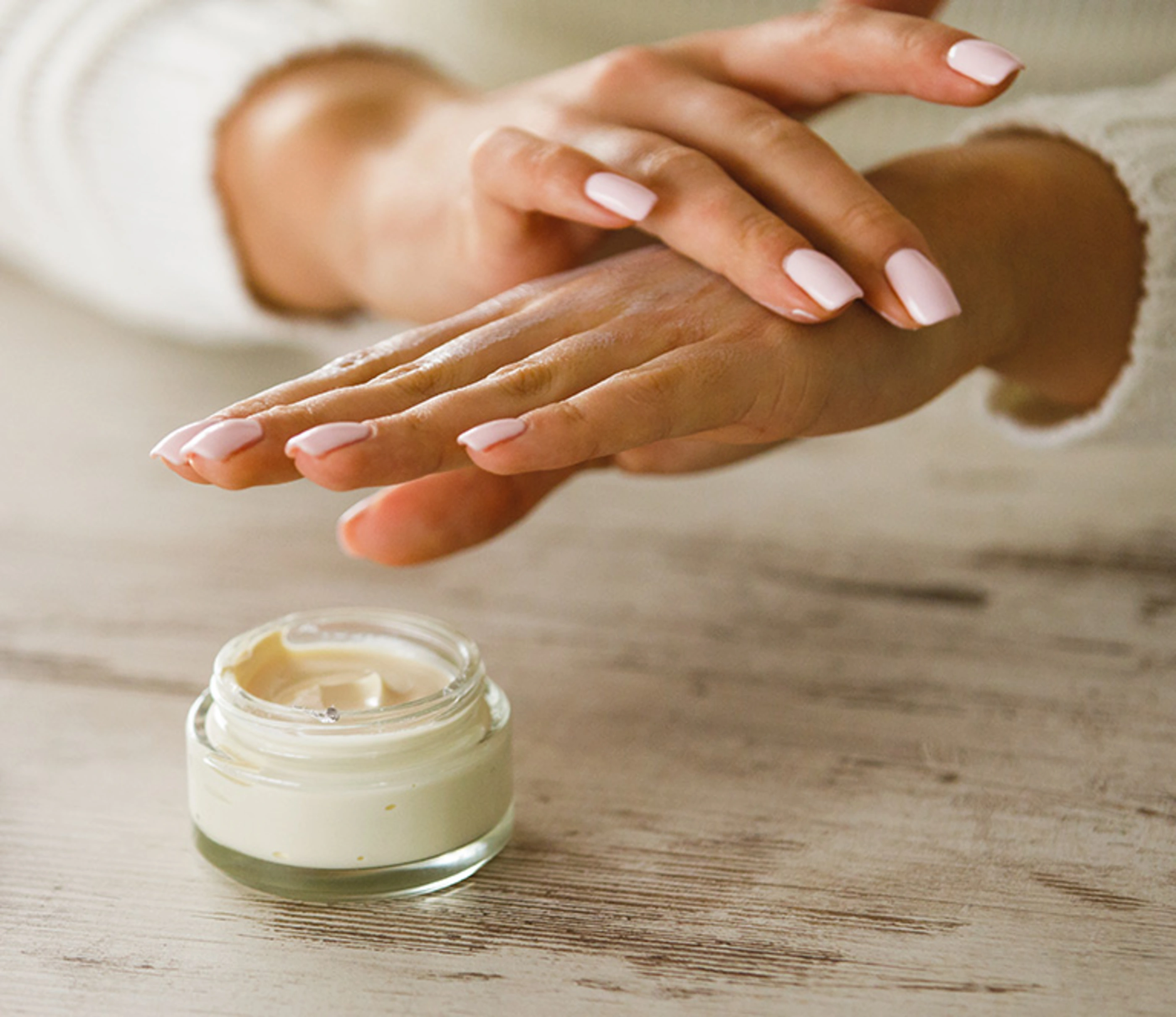 Person moisturizing hands with lotion.