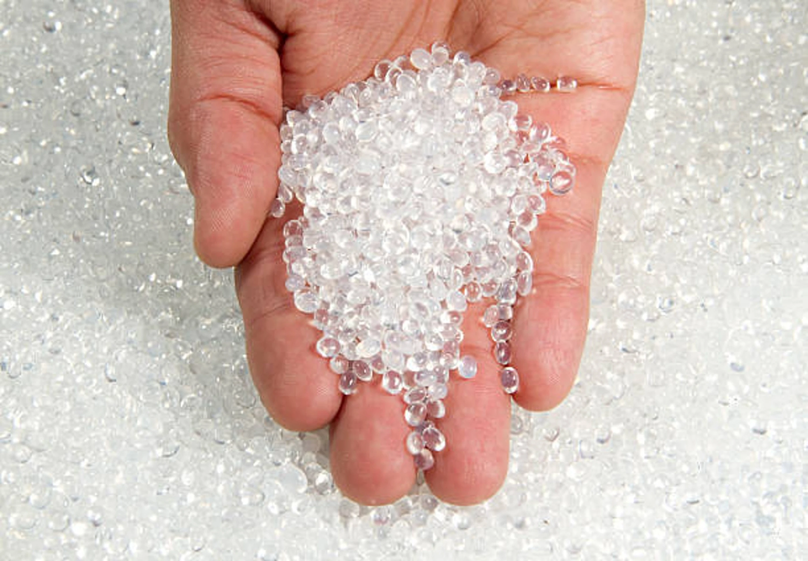 hand with clear pellets