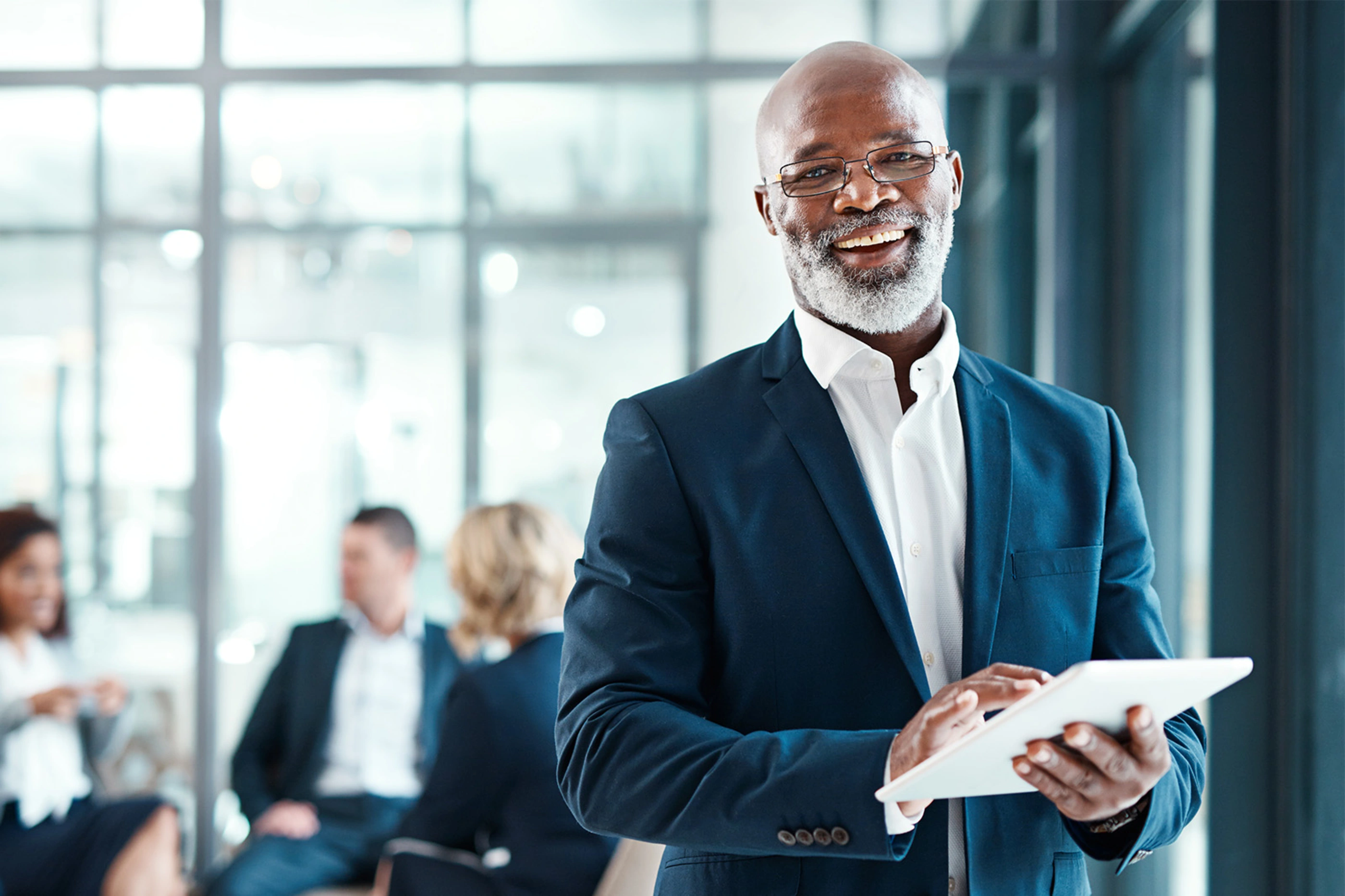 man in business suit at a company meeting in a modern office environment