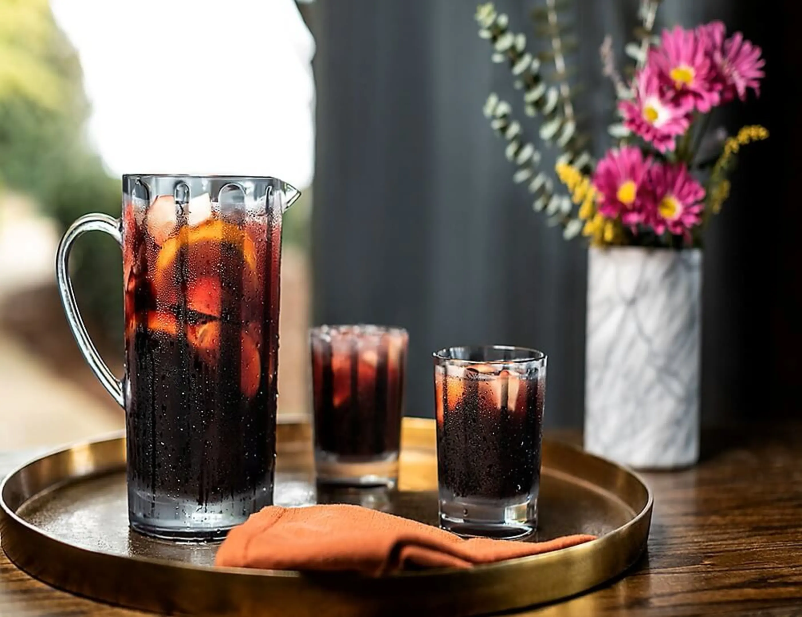 Pitcher and glasses filled with iced tea with lemon