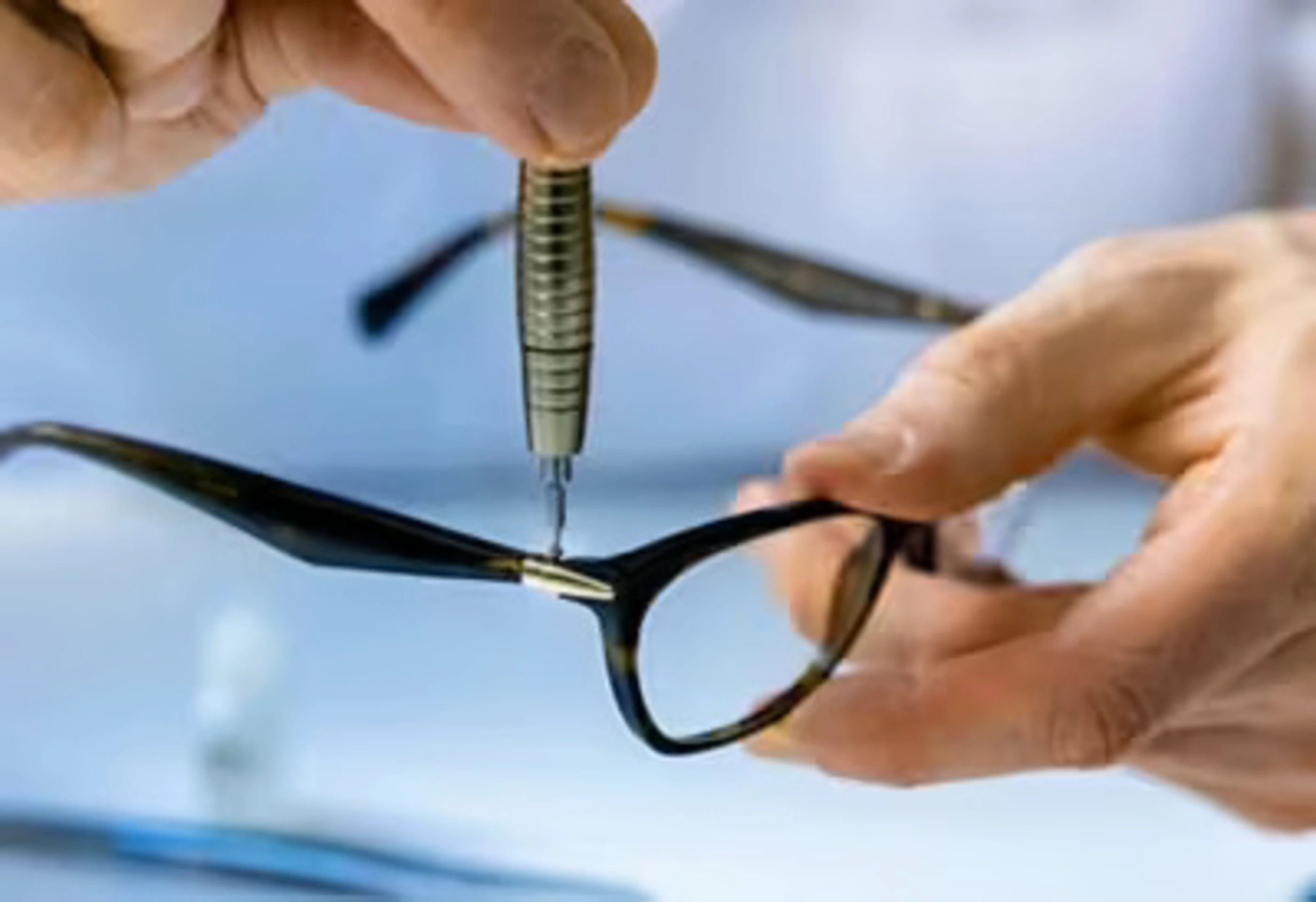 repairing leg of glasses with screwdriver