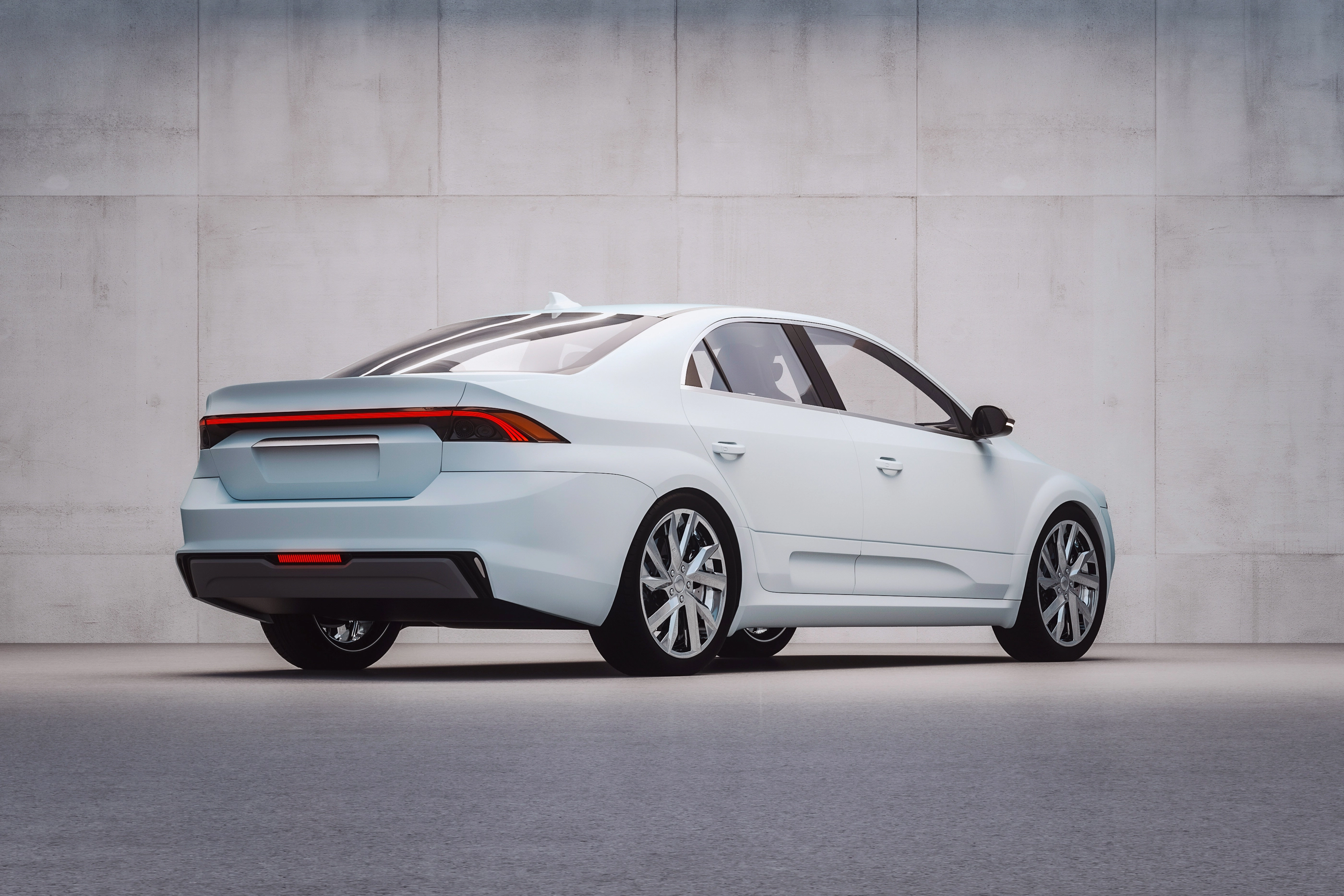 Generic modern car in front of concrete wall.