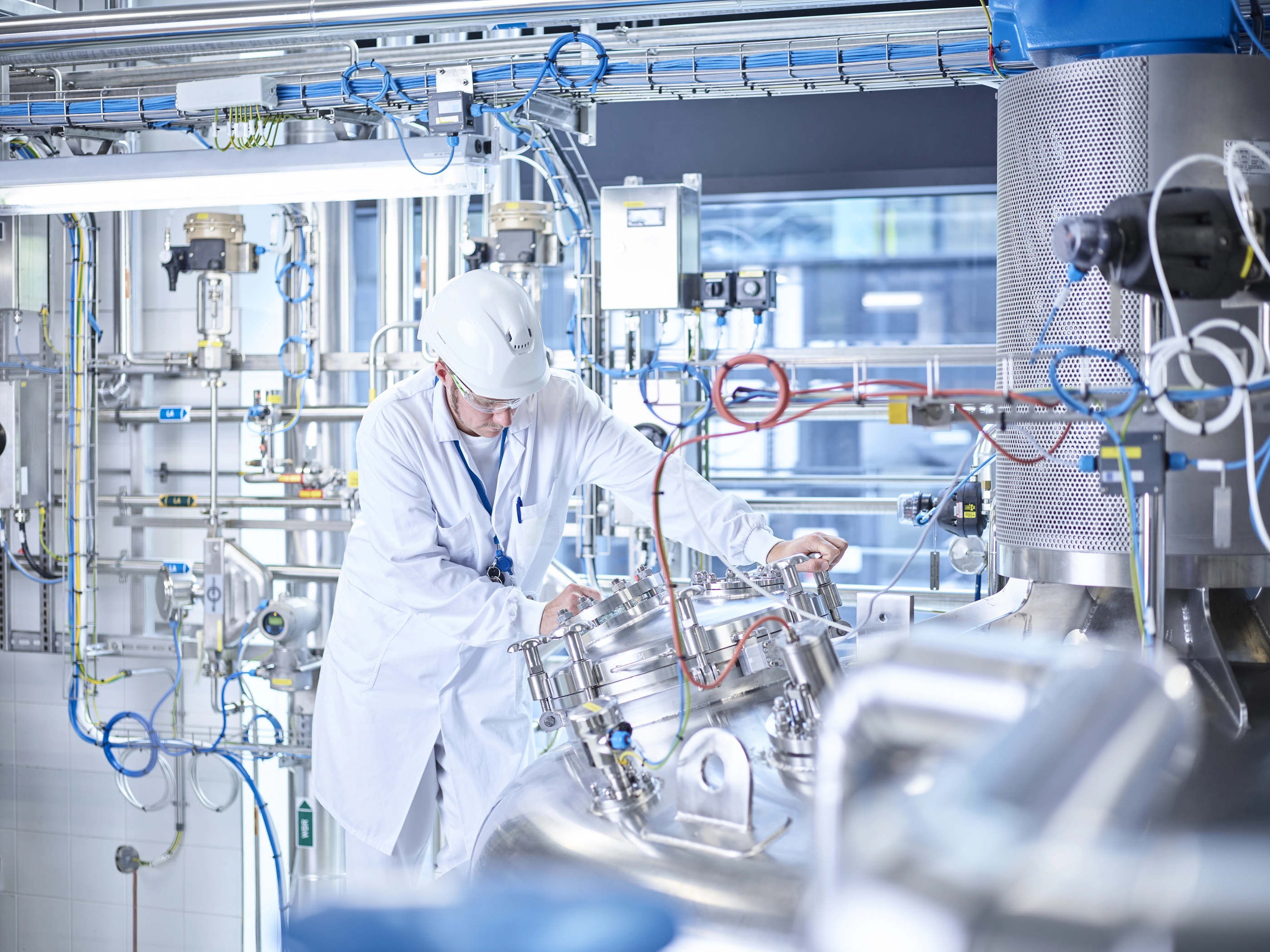 Chemist with helmet in chemical laboratory.