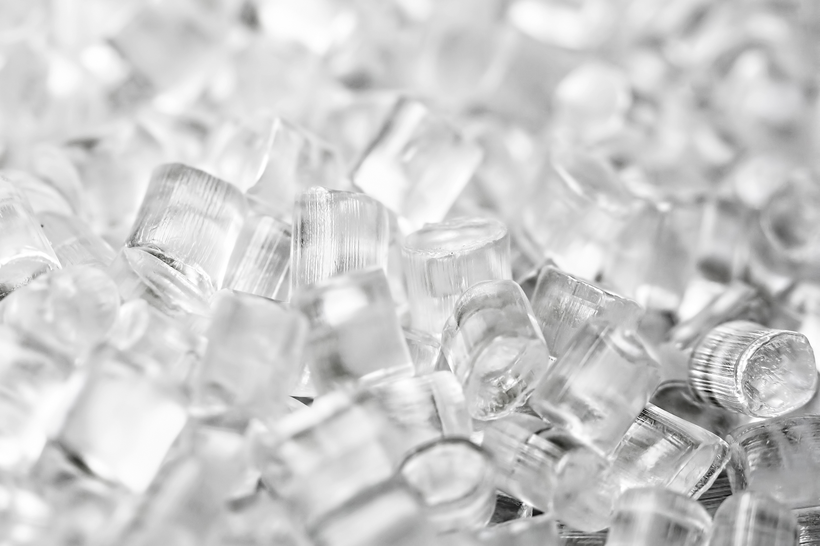 Transparent Plastic in granules. Polymer pellets. Isolated on a black background.