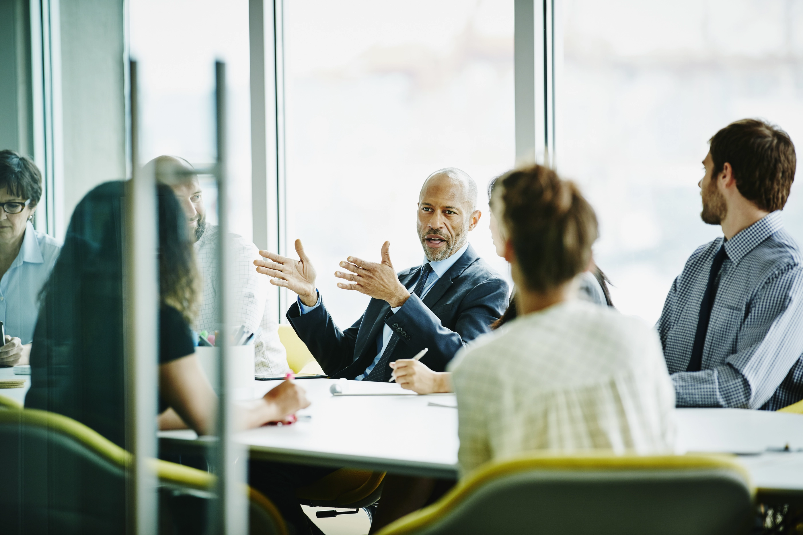 640127001 Mature businessman leading project meeting in office conference room