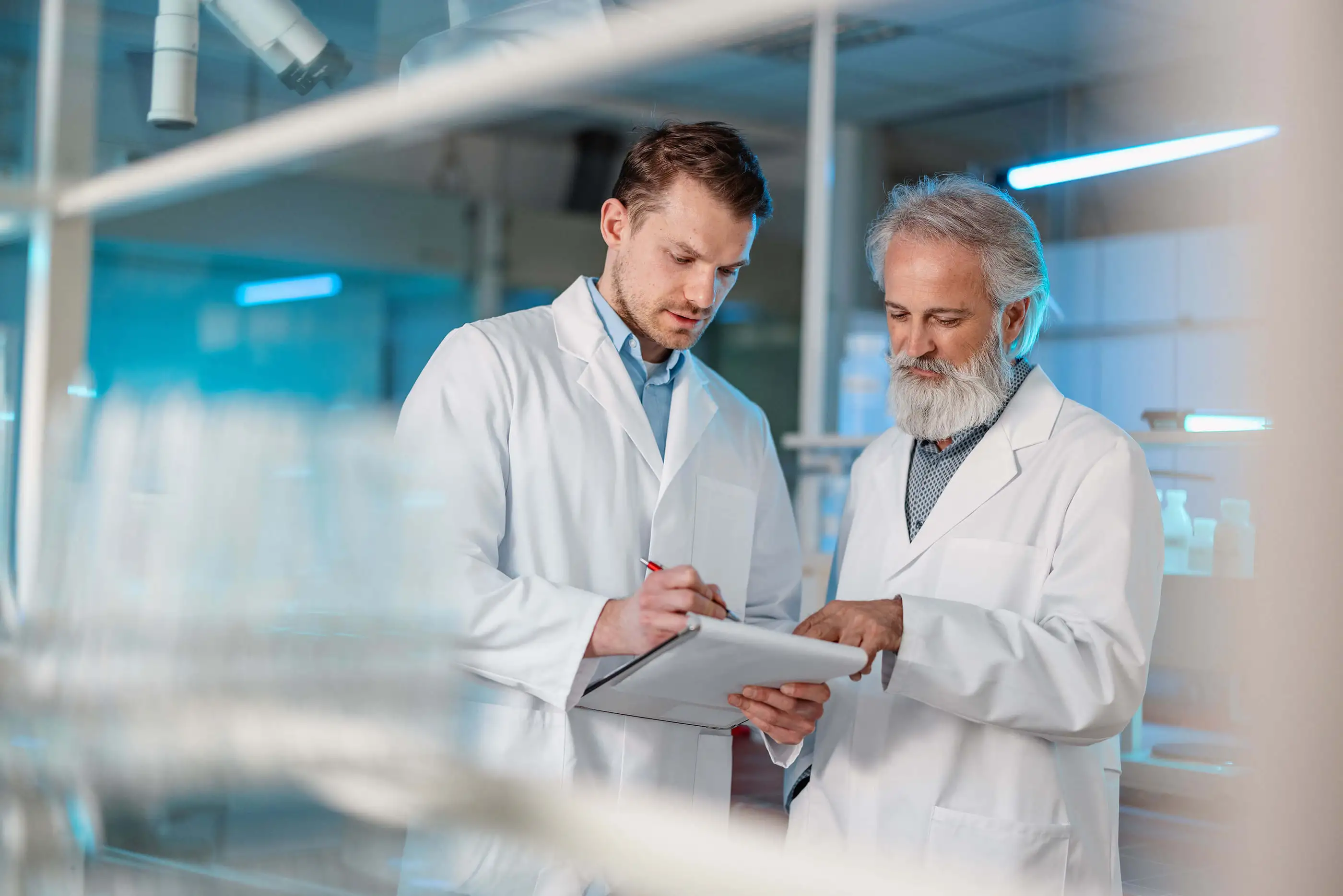 Two scientists in lab coats discussing results