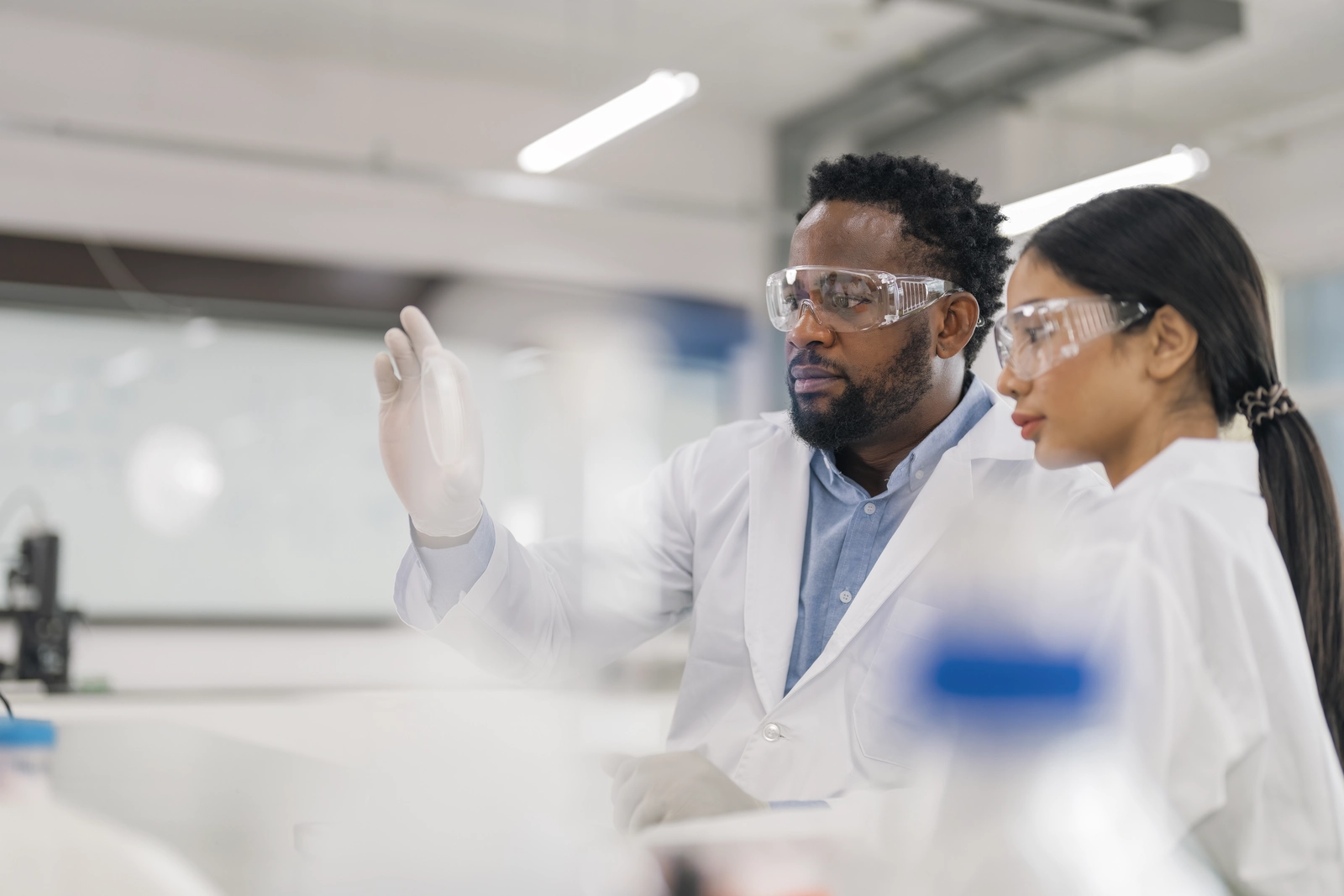 Scientists Working in Modern Medical Research Laboratory. Scientist Analysing Biochemicals Samples. Advanced Scientific Lab for Medicine, Microbiology Development.