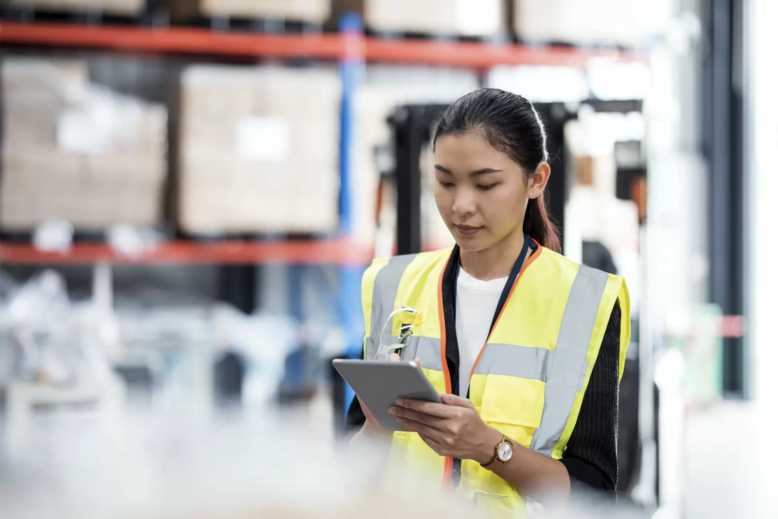 Days of Inventory on Hand in Distribution Warehouse. Asian Female Inventory Control staff using a digital tablet to inventory check real-time and report inventory while making recommendations on which items to order and restock.