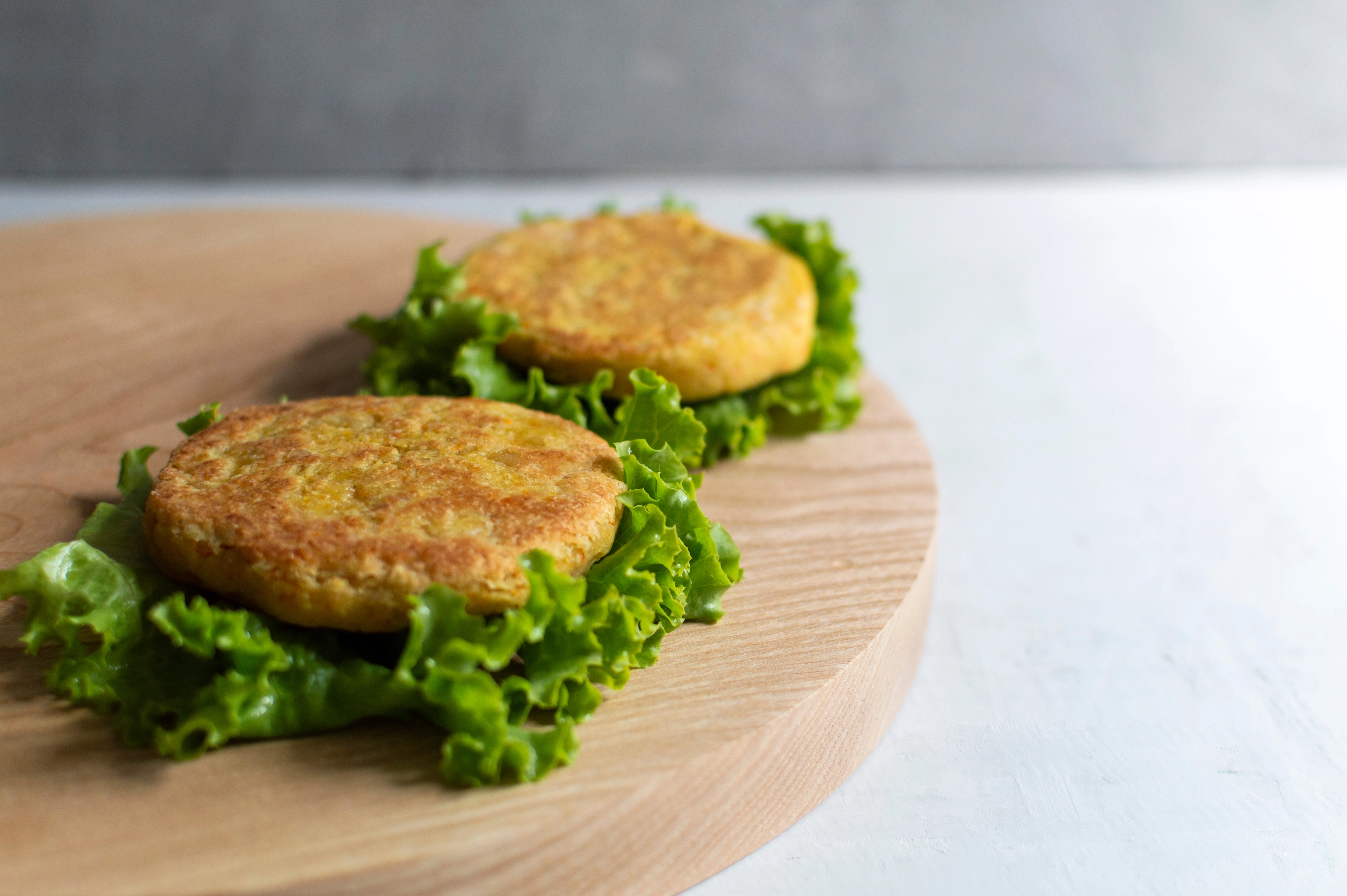 A beyond delicious plant based non meat burger(cutlets) with lettuce on a wooden board.  Home made with vegetables and chickpeas. Plant based food concept. Place for text.; Shutterstock ID 1802301130; purchase_order: nfi; job: ; client: ; other: 