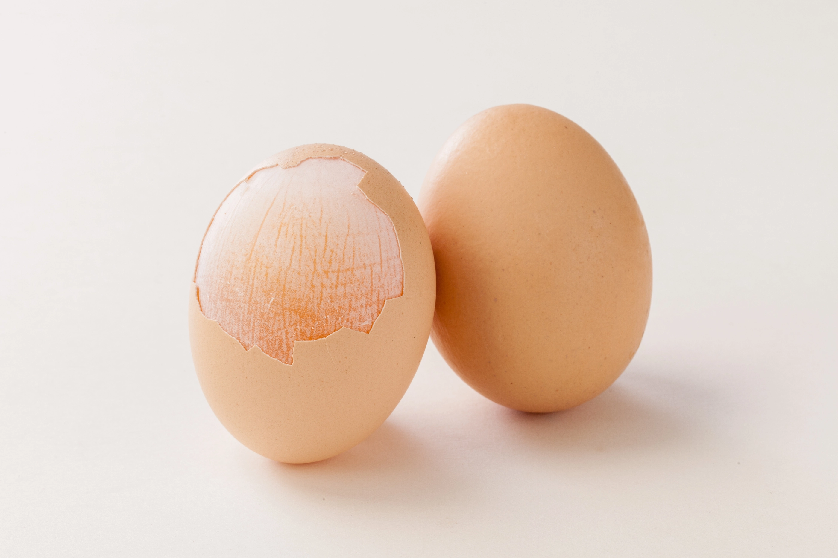 peeled egg shell expose the egg membrane on white background.; Shutterstock ID 2055244946; purchase_order: nfi; job: ; client: ; other: 