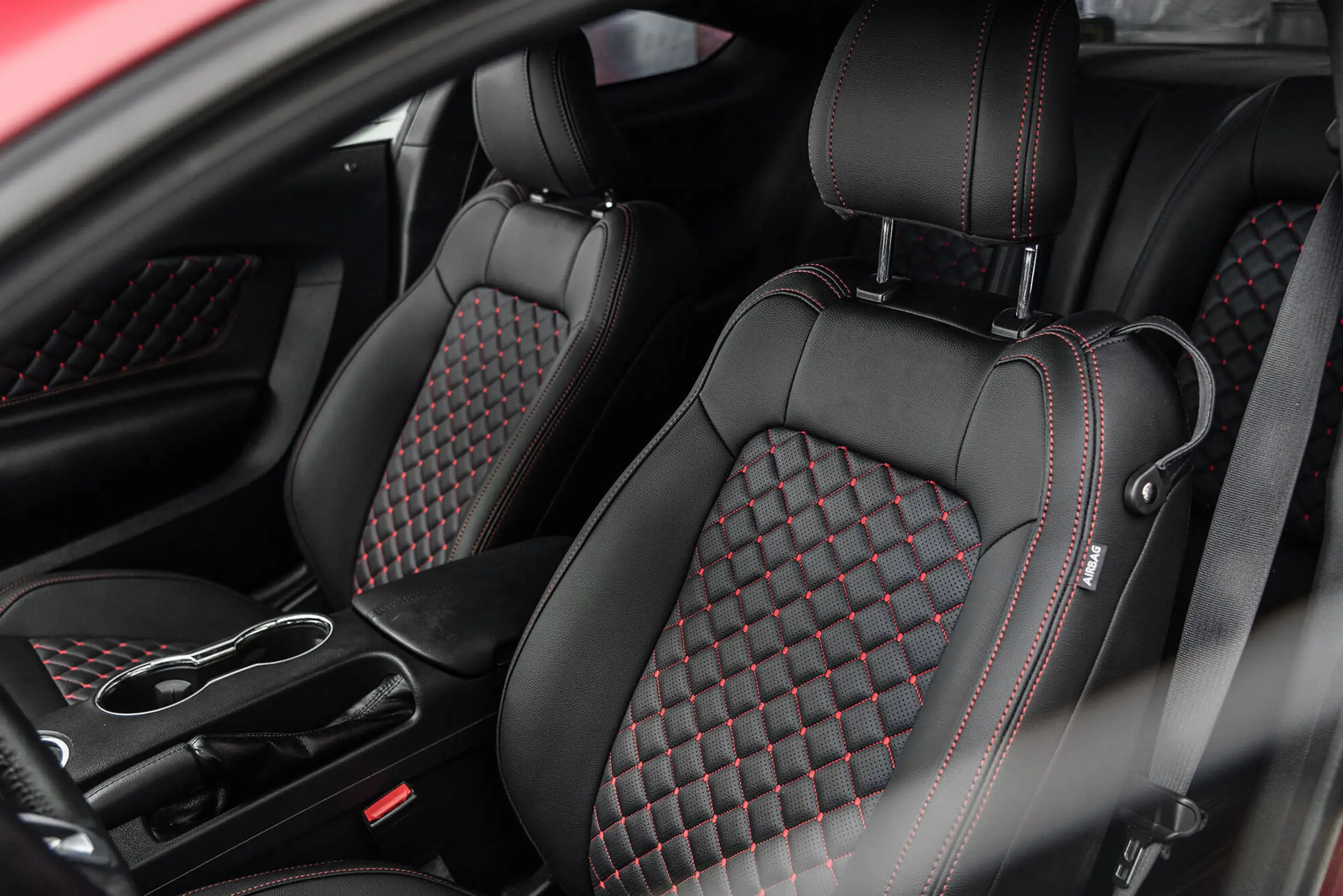 black leather car interior with red accents