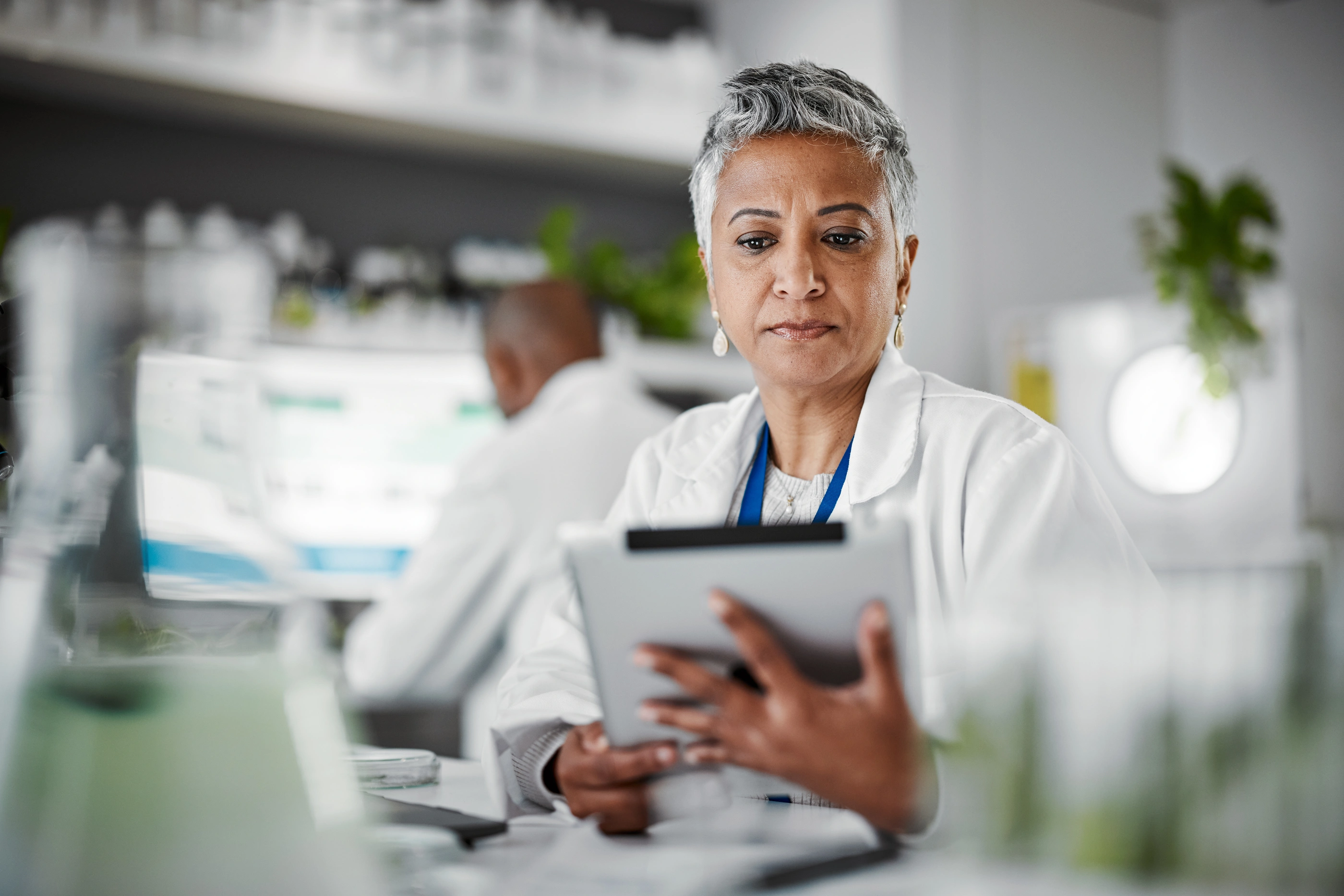 Woman, tablet or thinking in science laboratory for medical research, innovation or ideas for genetic gmo engineering. Plant scientist, worker or biologist on technology in growth sustainability data.