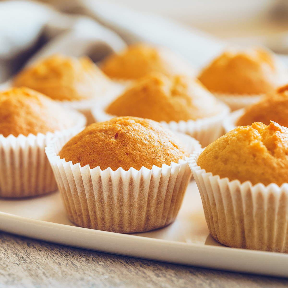 Unfrosted cupcakes on a white plate