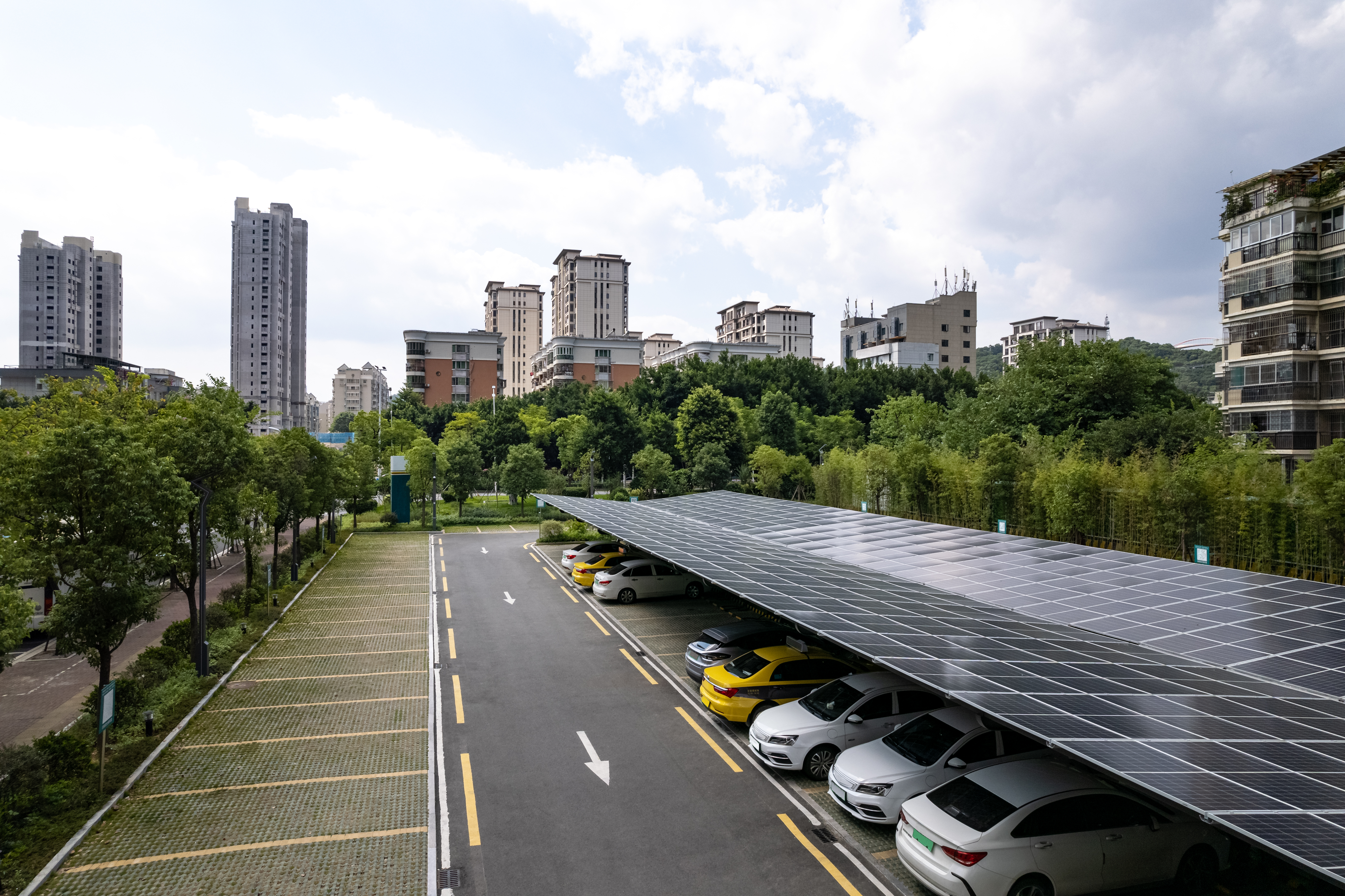 1350753765 Urban parking lot with solar panels on the roof